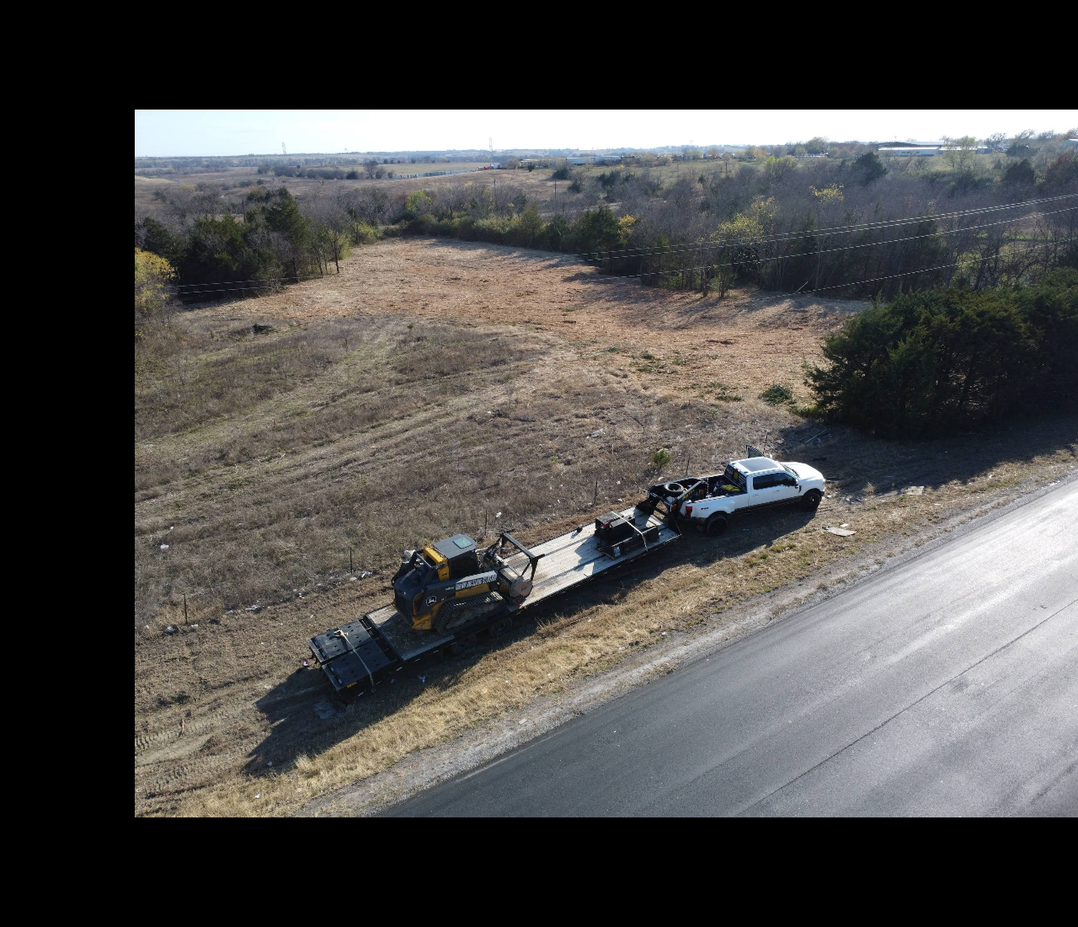 Aerial view of roadside equipment setup for land clearing and dirt work in Texas