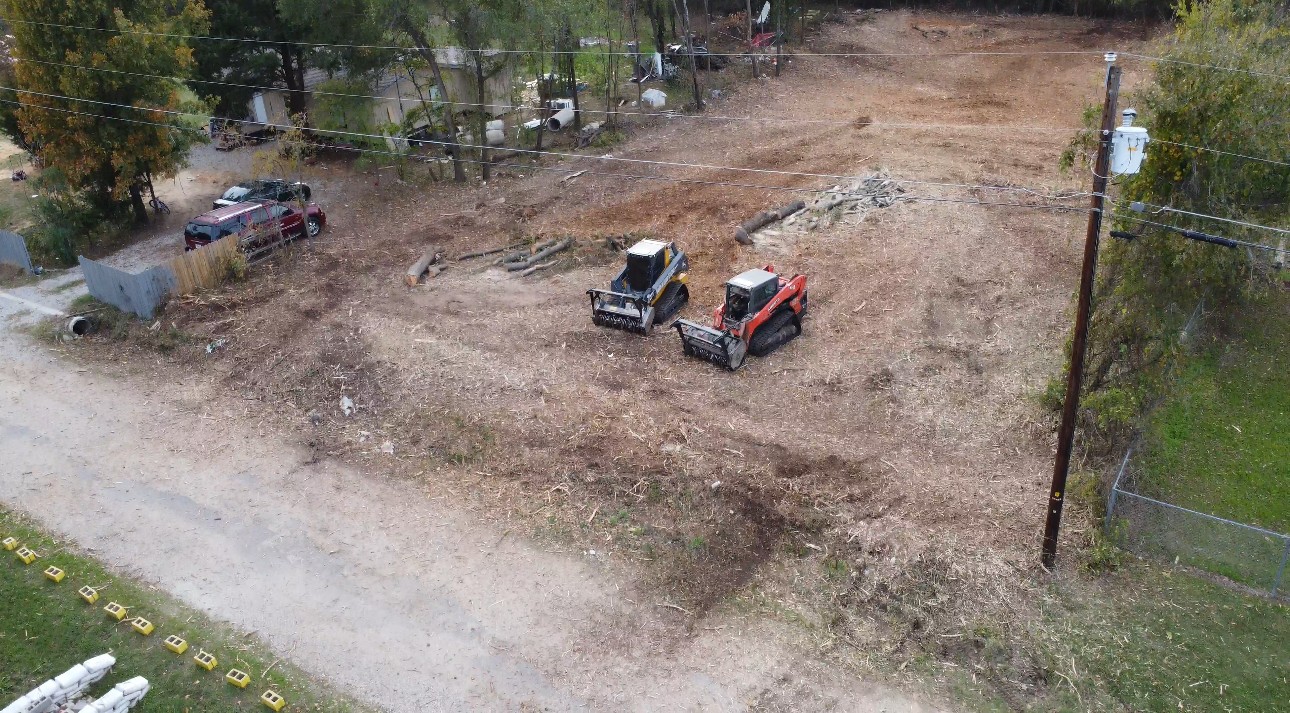 Overhead view of land clearing equipment on a cleared Texas property worksite